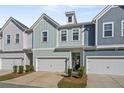 Charming townhome featuring colorful siding, a one-car garage, and manicured landscaping at 2901 Eddy Dr, Mount Pleasant, SC 29466