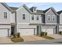 Charming townhome featuring colorful siding, a one-car garage, and manicured landscaping at 2901 Eddy Dr, Mount Pleasant, SC 29466