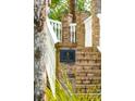 Elegant brick entrance featuring the property address, '3 Cross Lane,' amidst lush greenery at 3 Cross Ln, Isle of Palms, SC 29451