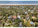 Picturesque aerial shot showcasing a vibrant coastal community with charming homes and ocean views at 3 Cross Ln, Isle of Palms, SC 29451