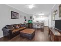 Cozy living room with open-concept design, hardwood floors, and a modern ceiling fan at 300 Bucksley Ln # 104, Charleston, SC 29492