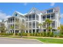 Three-story homes featuring charming screened-in porches and tropical landscaping at 3034 Bell Cv Aly, Johns Island, SC 29455