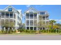 Three-story homes with screened-in porches and lovely tropical landscaping at 3034 Bell Cv Aly, Johns Island, SC 29455