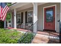 Inviting front porch with seating and a red door that reads 'hello.' at 309 Edinburgh St, Summerville, SC 29483