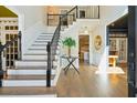 Welcoming foyer with hardwood floors, elegant staircase, and a view into the adjacent living spaces at 442 Channel Creek Ct, Mount Pleasant, SC 29464