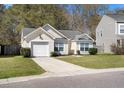 Charming one-story home with manicured lawn, driveway, and attached garage at 5024 Blair Rd, Summerville, SC 29483