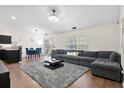 Spacious living room featuring a gray sectional, plush rug, and modern decor at 5024 Blair Rd, Summerville, SC 29483