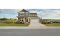 Charming two-story home featuring a covered porch, two car garage and professionally landscaped front yard at 615 Cottage Landing Dr, Summerville, SC 29485