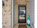 Cozy entrance featuring a decorative gnome and an inviting front door, creating a welcoming ambiance at 707 Redbud Ln, Summerville, SC 29486
