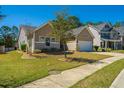 View of the home's exterior, including well-maintained landscaping and an attached two car garage at 718 Kilarney Rd, Summerville, SC 29483