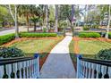 Inviting walkway leading to the home, framed by lush landscaping and an adorable fence for great curb appeal at 724 Hibbens Grant Blvd, Mount Pleasant, SC 29464