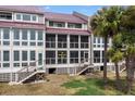 Rear view of condominiums with screened porches and access to ground level at 76 Mariners Cay Dr, Folly Beach, SC 29439