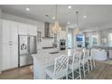 Modern kitchen featuring stainless steel appliances, a large island with seating, and pendant lighting at 824 Forrest Dr, Charleston, SC 29492