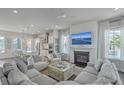 Bright living room with fireplace, large windows, and comfortable seating, flowing into modern kitchen at 824 Forrest Dr, Charleston, SC 29492