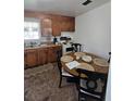 The kitchen features wood cabinets, a window, a small eating area, and a basic stove at 824 Orangeburg Rd, Summerville, SC 29483