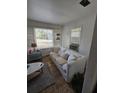 A bright living room with a large window and a comfortable sofa with neutral decor at 824 Orangeburg Rd, Summerville, SC 29483