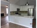 Modern kitchen with stainless steel appliances, white cabinets, and an island counter at 8309 Berringer Bluff, North Charleston, SC 29418