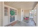 Inviting front porch featuring a rocking chair, a wreath, and a welcoming ambiance at 886 Piccadilly Cir, Charleston, SC 29412