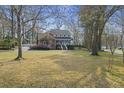 This home features a brick accent, blue shutters, a welcoming front porch, and a large lawn at 100 Lakeview Dr, Summerville, SC 29485