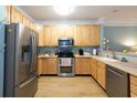 Bright kitchen with stainless steel appliances and light wood cabinetry at 1025 Riverland Woods Pl # 907, Charleston, SC 29412
