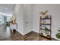Clean hallway with wood-look flooring, neutral paint, and decorative shelving creating an inviting entrance at 107 Willett Ln, Summerville, SC 29486
