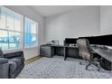 Bright home office with large windows, a spacious desk, and comfortable seating area for work or relaxation at 107 Willett Ln, Summerville, SC 29486