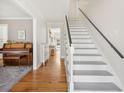 Bright hallway with hardwood floors, stairs, and views into the living room and other areas at 109 Buckingham Ave, Summerville, SC 29485