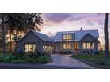 Charming craftsman home with metal roof, covered porch at dusk at 111 Peninsula Dr, Ravenel, SC 29470