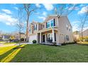 Attractive two-story home featuring a two-car garage and a covered porch, surrounded by a well-maintained lawn at 1309 Belgian Draft Dr, Mount Pleasant, SC 29466