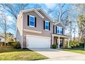 Beautiful two-story home with a two-car garage and an inviting covered front porch at 1309 Belgian Draft Dr, Mount Pleasant, SC 29466