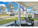Inviting front porch with cozy seating, overlooking a peaceful street and well-maintained neighborhood at 131 Swaying Palm Dr, Summerville, SC 29485