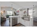 Bright kitchen features white cabinets, stainless steel appliances, and a large island with a stainless steel sink at 156 Woodward Rd, Goose Creek, SC 29445
