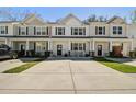 Inviting townhome with a concrete driveway and manicured lawn perfect for curb appeal at 158 Spencer Cir, Summerville, SC 29485