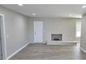 Open living room featuring a fireplace and gray vinyl plank flooring throughout the space at 159 Foxborough Rd, Goose Creek, SC 29445