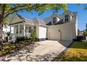 Traditional home featuring an attached two-car garage and well-maintained landscaping at 171 Cartright St, Charleston, SC 29492
