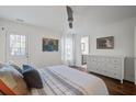 Cozy main bedroom featuring white walls, hardwood floors, and an ensuite bathroom at 1728 Barracuda Rd, Johns Island, SC 29455