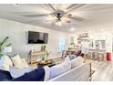 Open-concept living room with modern furnishings and a view into the kitchen area at 187 Red Blf St, Summerville, SC 29483