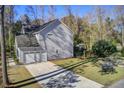 Backyard featuring a two-car garage, green space, and raised garden beds at 1926 Grimball Rd, Charleston, SC 29412