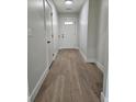 Inviting hallway featuring hardwood floors, neutral paint and white doors at 212 Regent St, Summerville, SC 29483