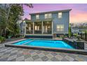 Stunning backyard pool with patterned tile surround, built-in waterfall feature, and a screened-in porch at 2415 Jasper Patterson Dr, Johns Island, SC 29455