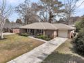 Aerial view of brick single-story home with a driveway and front yard, showcasing its setting at 303 Gippy Dr, Summerville, SC 29486