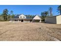 Home exterior featuring a metal roof and a damaged porch with yard debris at 305 Sandridge Rd, Dorchester, SC 29437