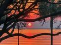 Beautiful waterfront view featuring a bright sun hanging low over the horizon at 32 Prioleau St # N, Charleston, SC 29401