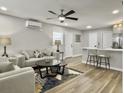 Inviting living room with modern ceiling fan, two sofas, accent rug, and seamless flow to the kitchen at 33 Athens Ct, Charleston, SC 29403