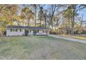 A well-maintained one story home featuring nice landscaping, a brick exterior, and a driveway leading to the property at 402 Corey Blvd, Summerville, SC 29483