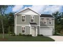 Two-story home featuring gray siding, white trim, a well-manicured lawn, and an attached two-car garage at 4171 Rising Tide Dr, Summerville, SC 29485