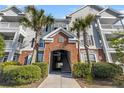 Exterior entrance of a condo complex with palm trees and well-maintained landscaping at 45 Sycamore Ave # 626, Charleston, SC 29407
