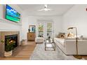 Bright living room with a fireplace, ceiling fan, balcony access, and comfortable seating at 45 Sycamore Ave # 626, Charleston, SC 29407