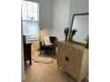Bright sitting area with a chair, mirror, and cabinet at 45 Sycamore Ave # 626, Charleston, SC 29407