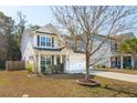 Beautiful home featuring manicured landscaping, two-car garage, and a welcoming front entrance at 467 Nelliefield Trl, Wando, SC 29492